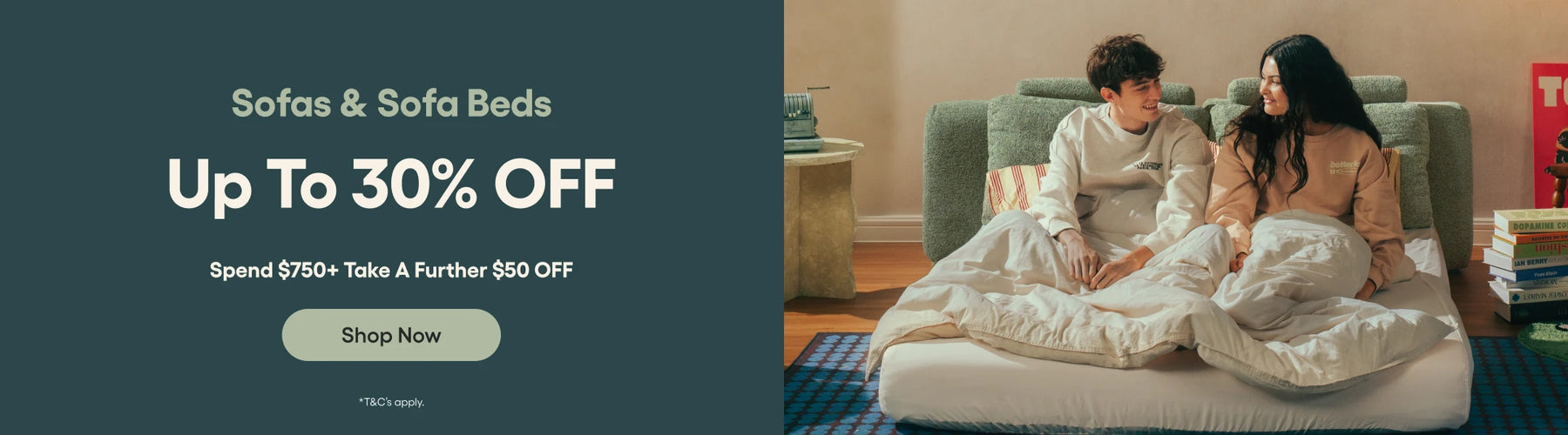 Promotional banner for sofas and sofa beds with a couple on a bed, text overlay, and call to action button.
