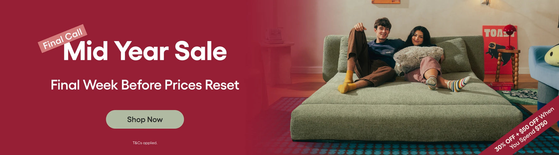 Promotional banner for a mid-year sale with a couple on a couch.