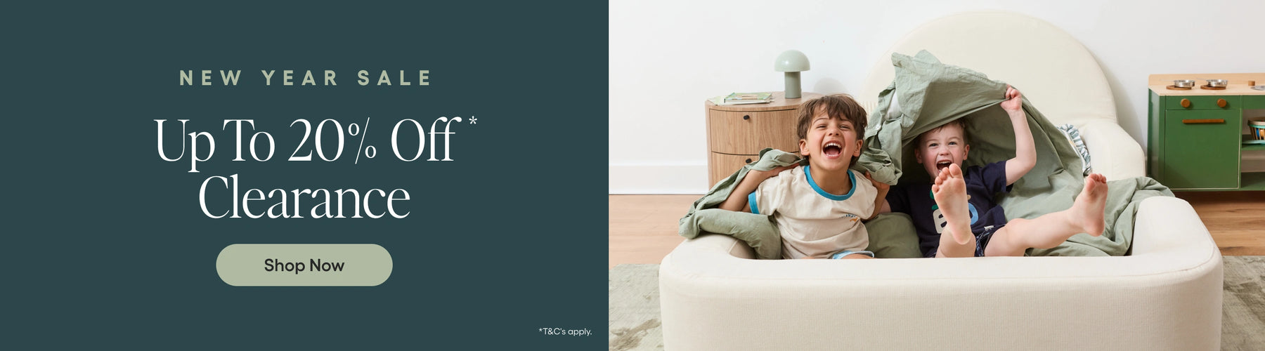 Children playing on a couch with a New Year Sale banner overlay.