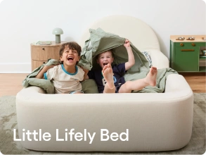 Two children laughing and sitting inside a cream-colored upholstered bed frame in a bright room. The text 'Little Lively Bed' is overlaid at the bottom left.