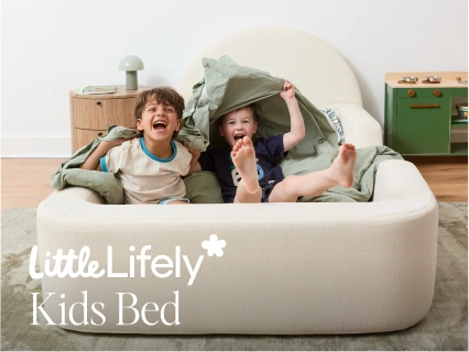 Two children playing on a Little Lifely kids bed in a room with furniture.