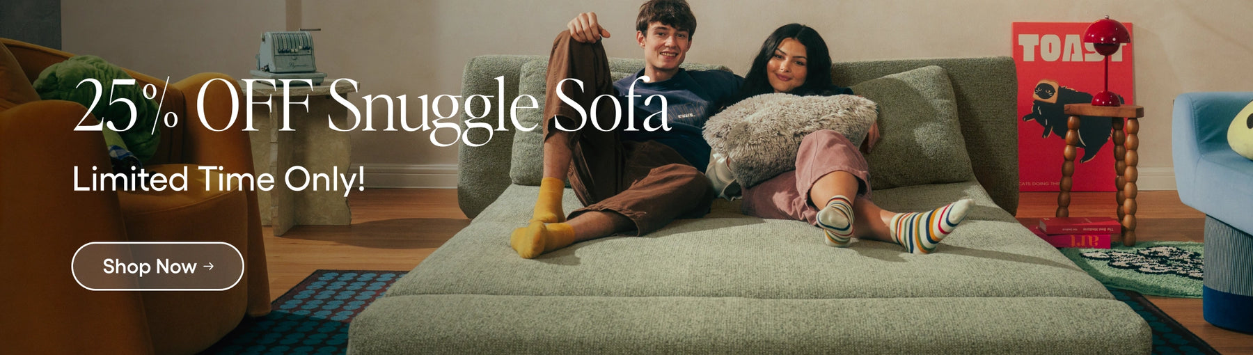 Two people sitting on a sofa with promotional text for Snuggle Sofa discount.